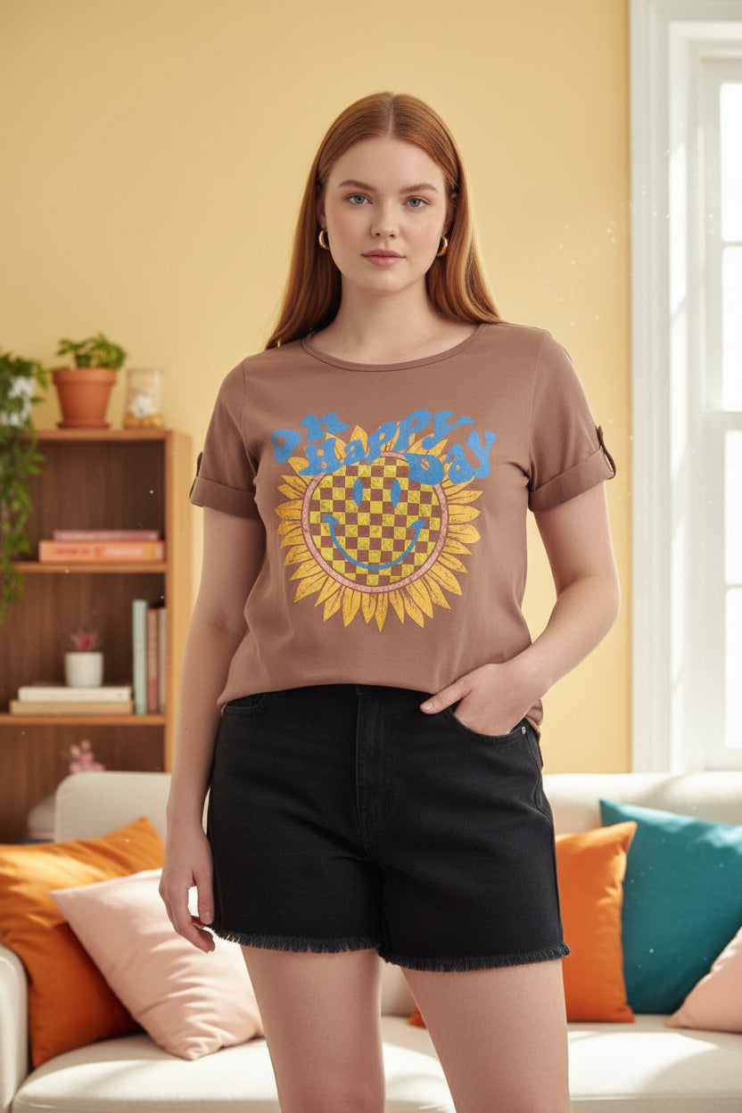 Woman wearing a brown t-shirt with a colorful graphic design on a white background