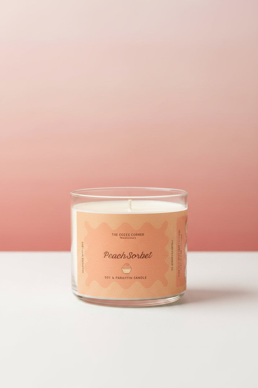 Candle with a peach sorbet label on a wooden surface